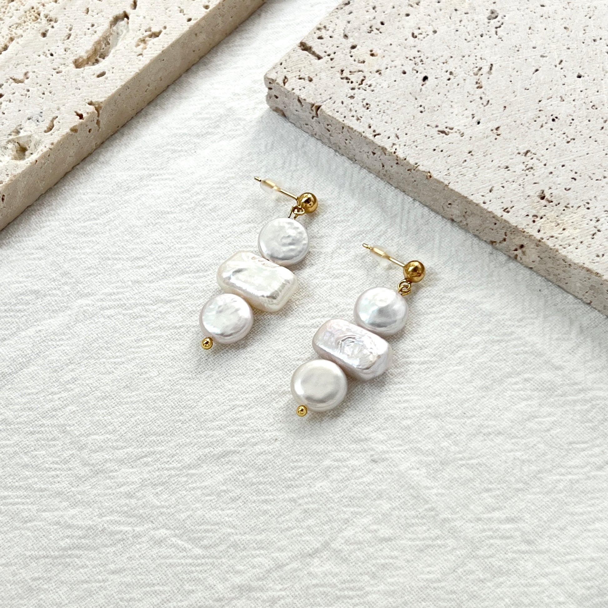 Side view of 14K gold baroque pearl coin rectangle earrings showing natural pearl luster