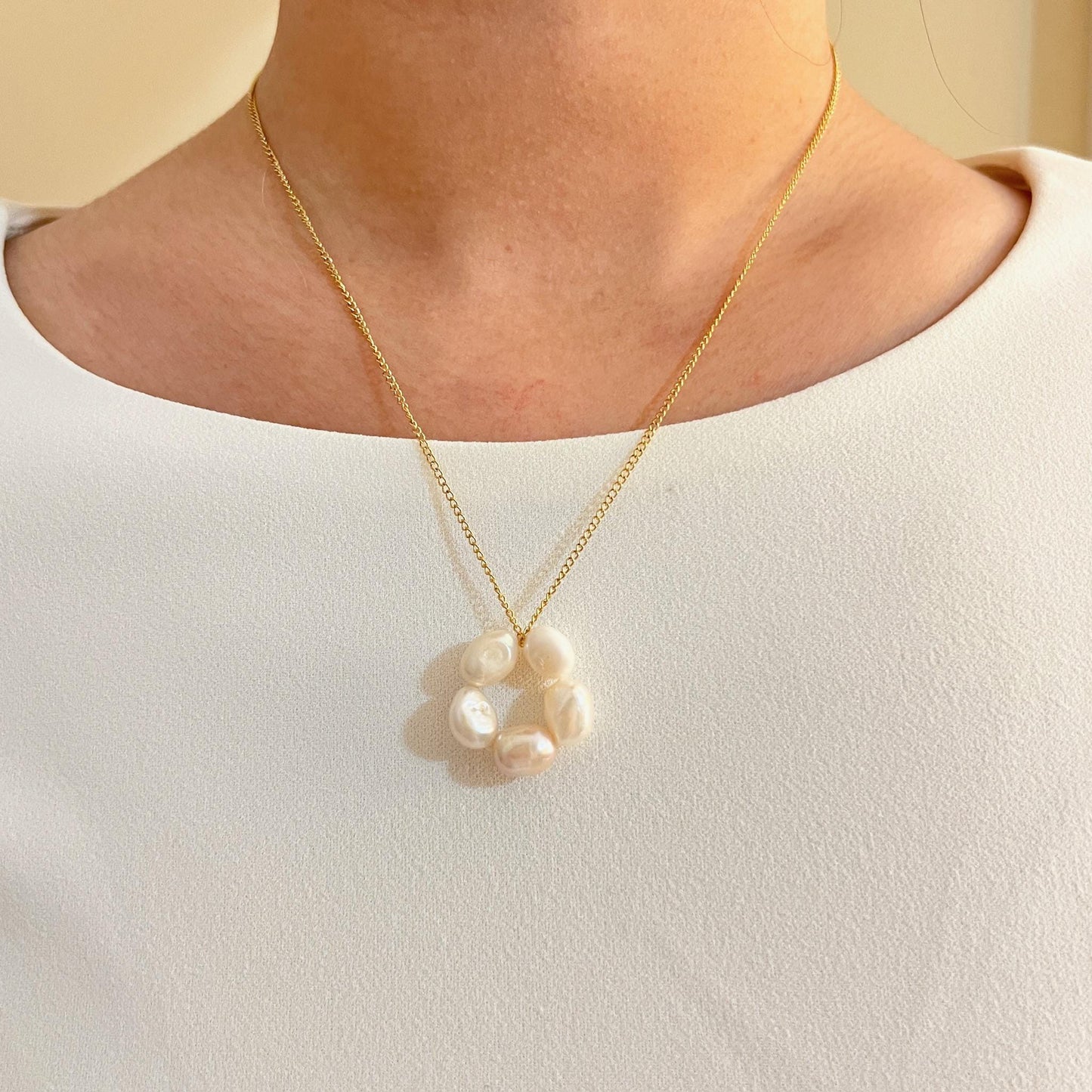 Woman wearing 14K gold-filled baroque pearl flower necklace, perfect for weddings or bridesmaid gifts