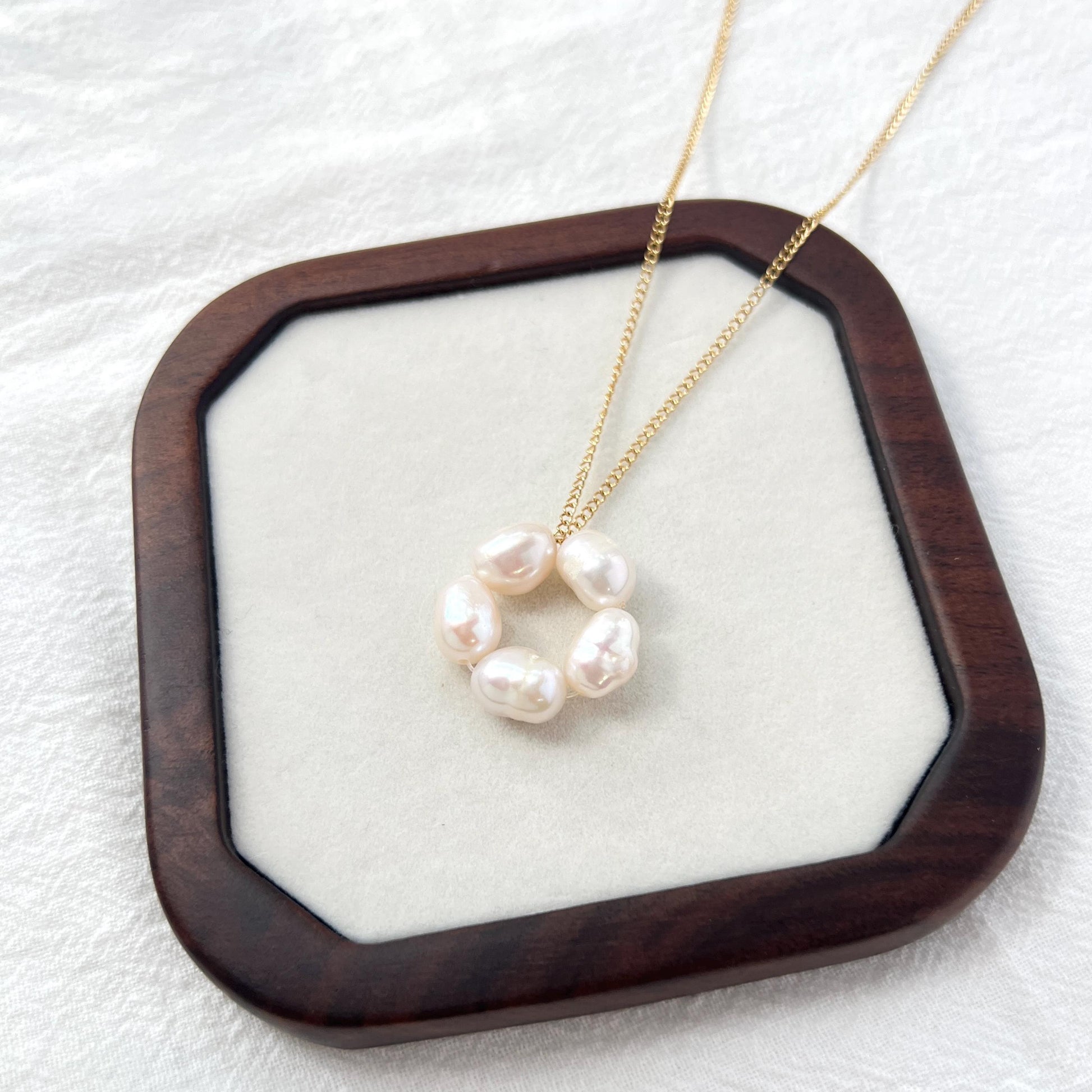 Close-up of 14K gold-filled baroque pearl flower necklace, showing delicate floral design