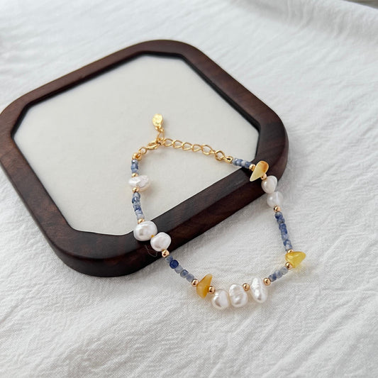 Front view of 18K gold bracelet with baroque pearls, lapis lazuli, and beeswax beads