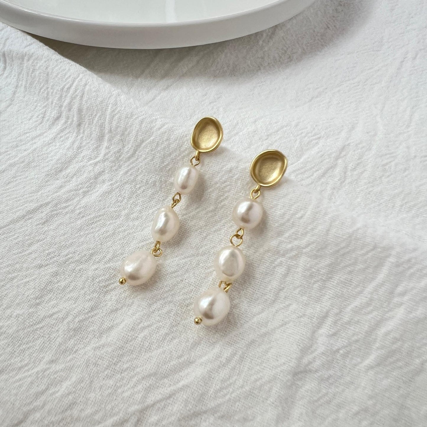 Close-up of baroque freshwater pearls with matte gold finish