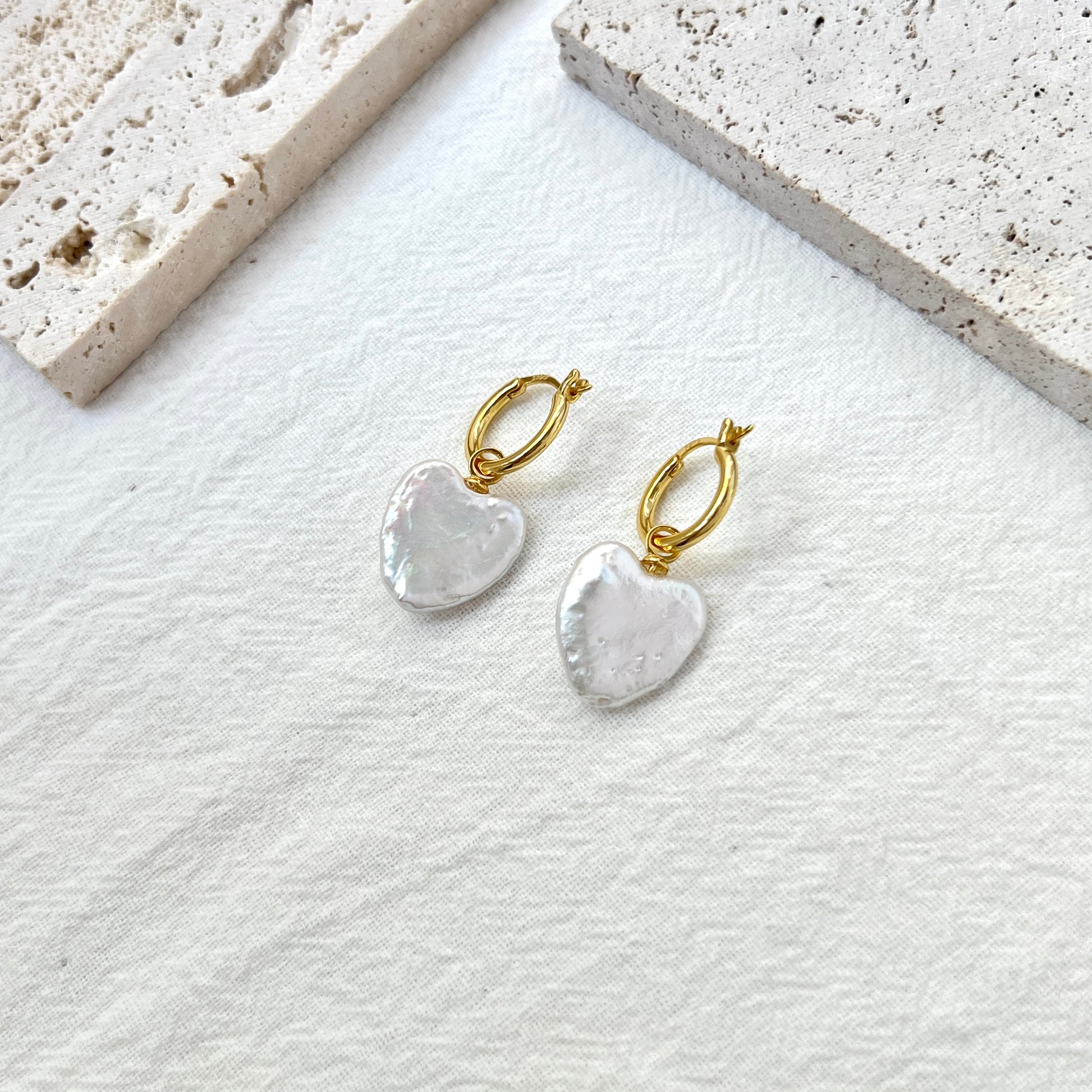 Close-up of heart baroque freshwater pearls with gold hoops