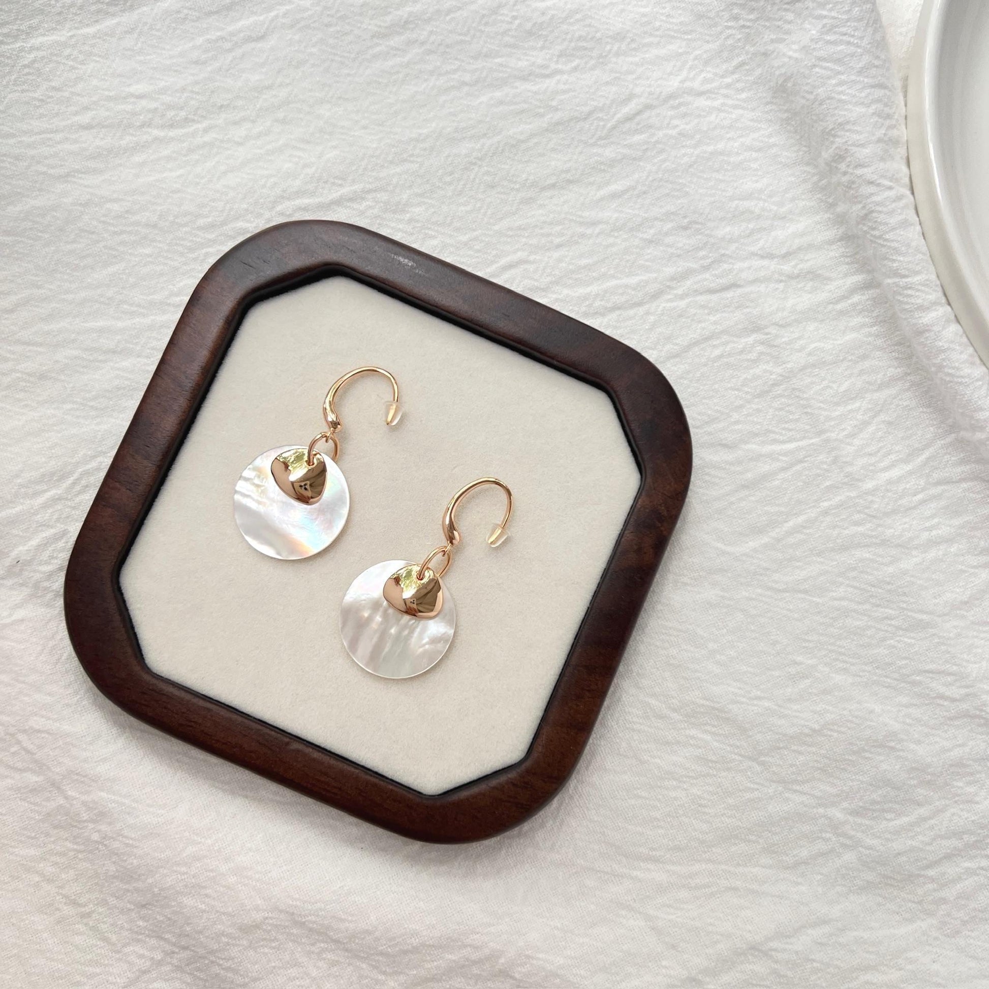 Ocealine Jewelry branding image featuring 18K gold mother-of-pearl earrings
