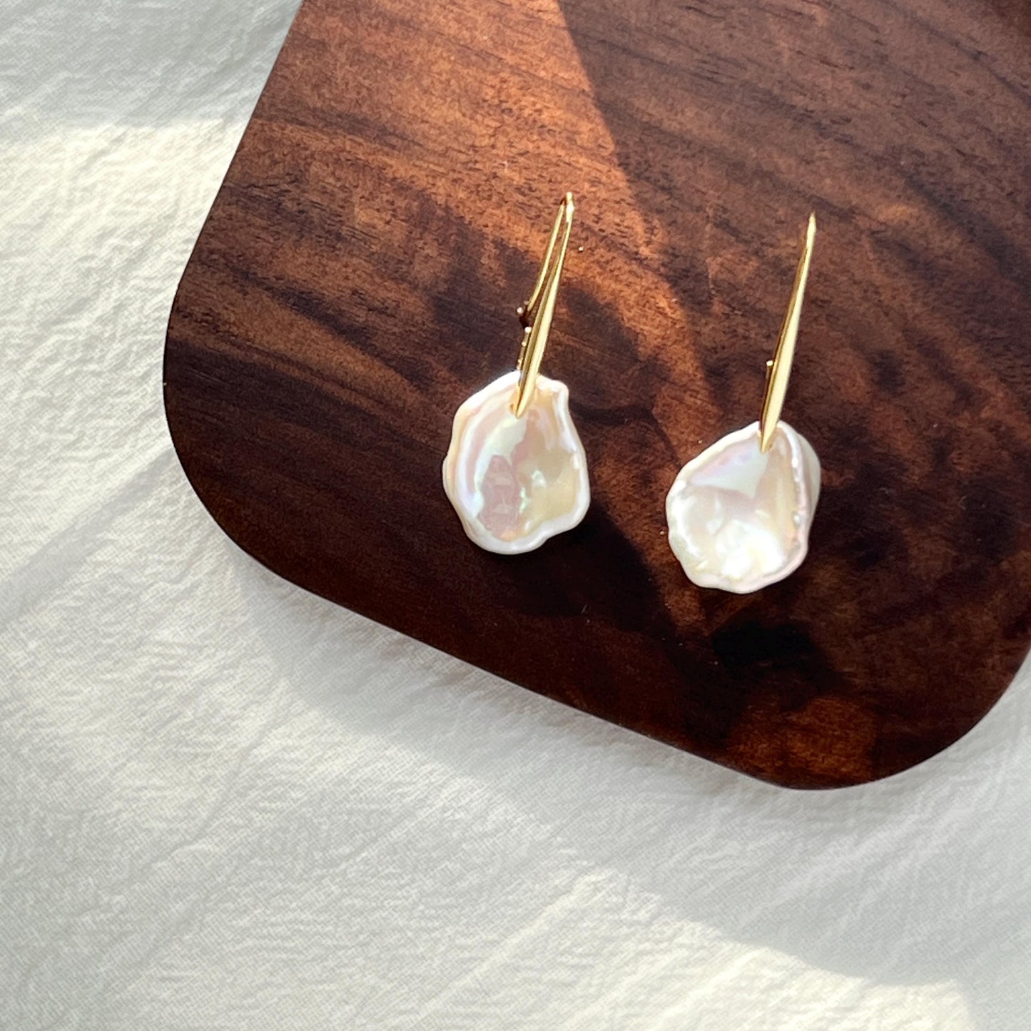 Ocealine Jewelry branded image featuring gold baroque pearl petal earrings