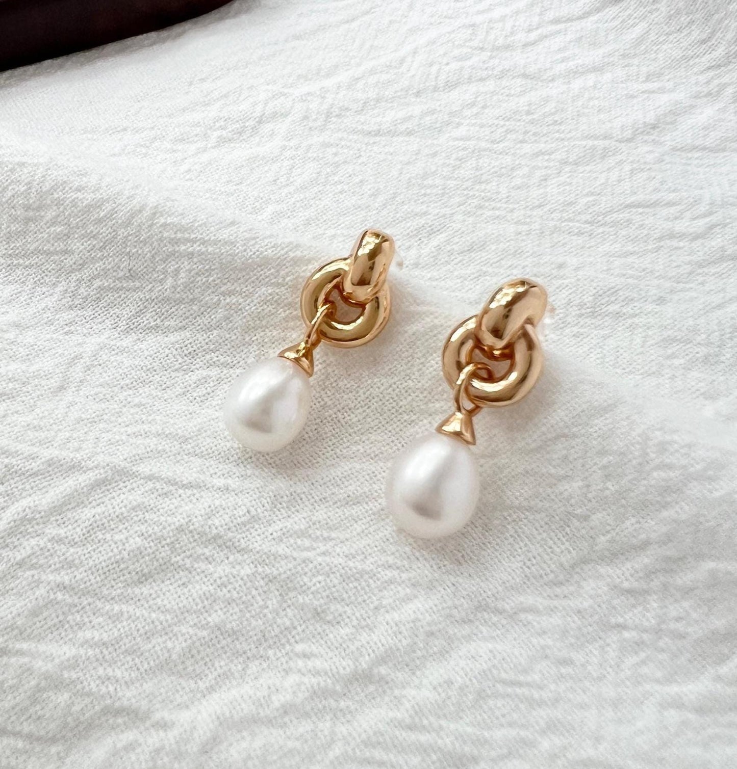 Ocealine Jewelry branding image featuring 18K gold vintage pearl dangling earrings with Celtic knot design