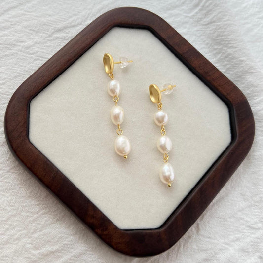 Side view of 18K matte gold natural baroque pearl drop earrings