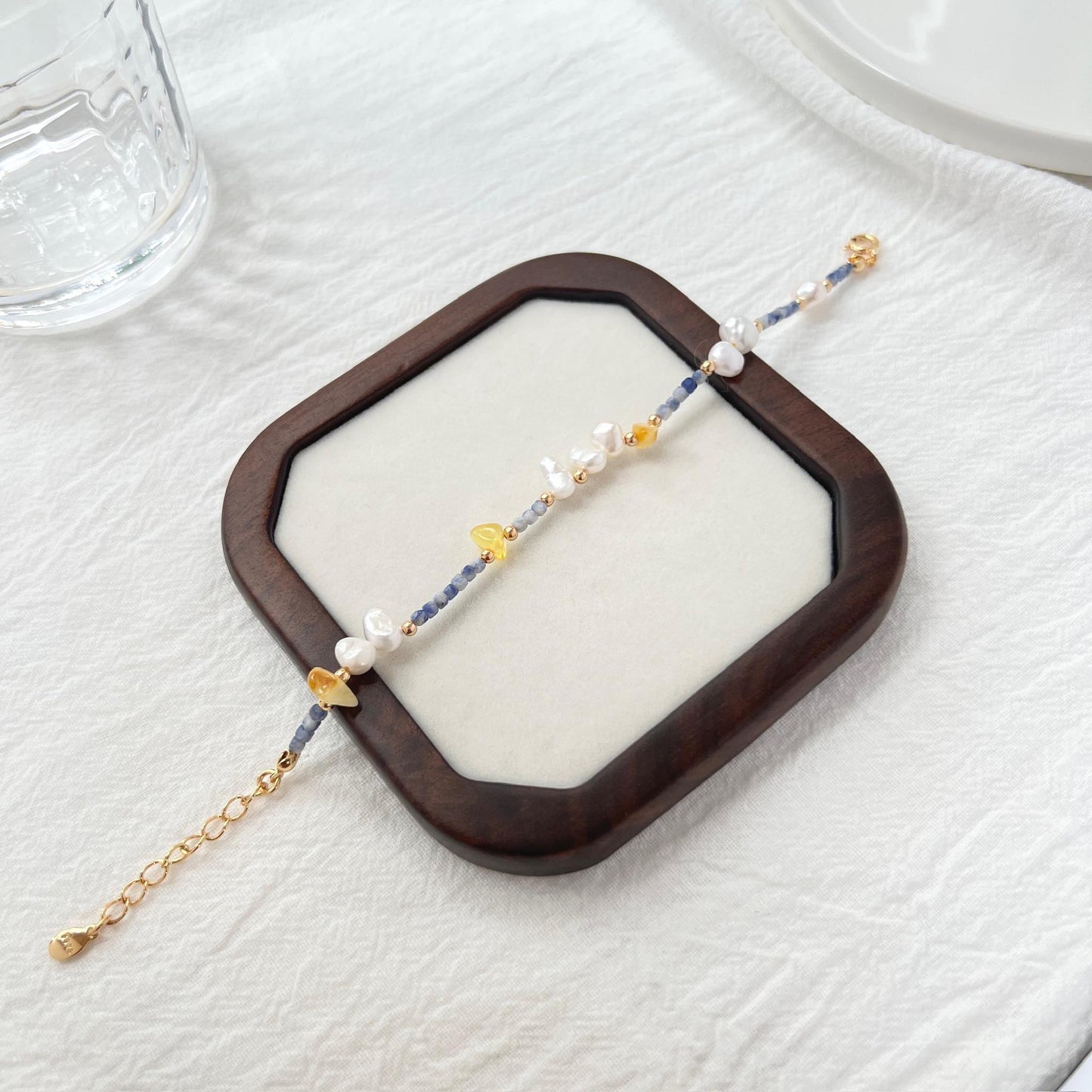 Side view showing 18K gold beaded bracelet with colorful stones