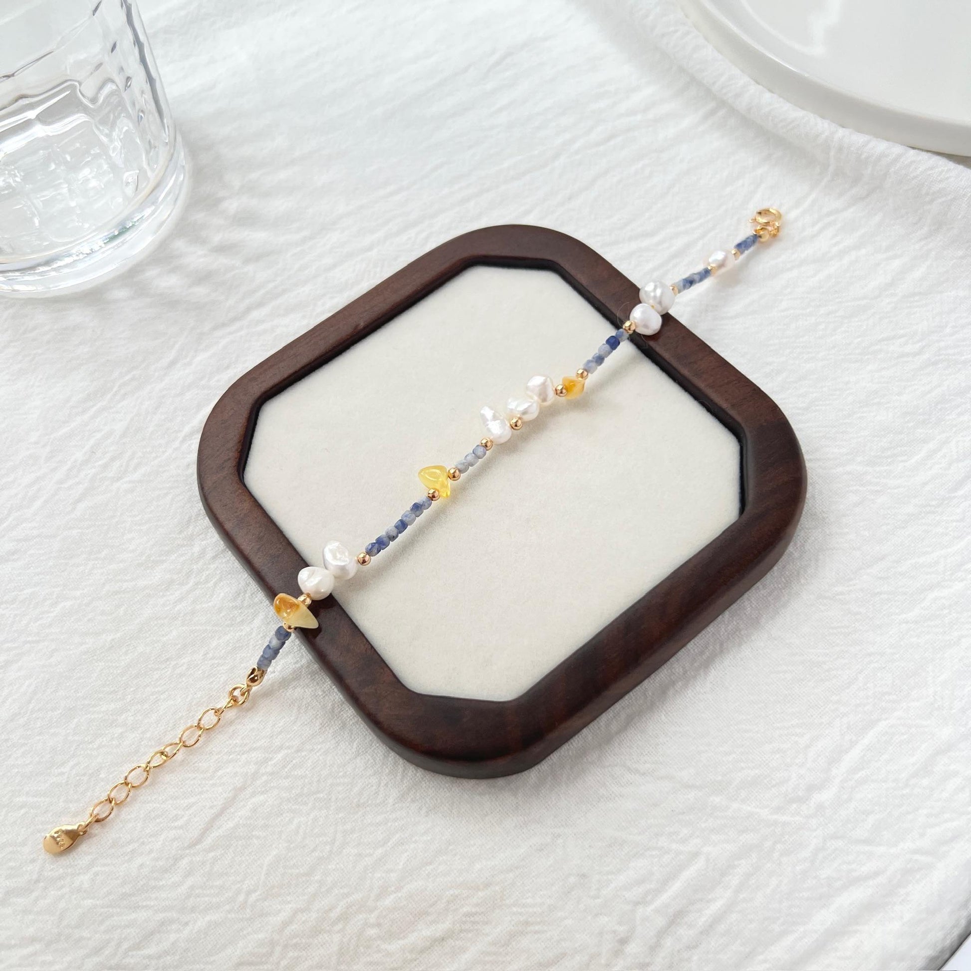 Side view showing 18K gold beaded bracelet with colorful stones