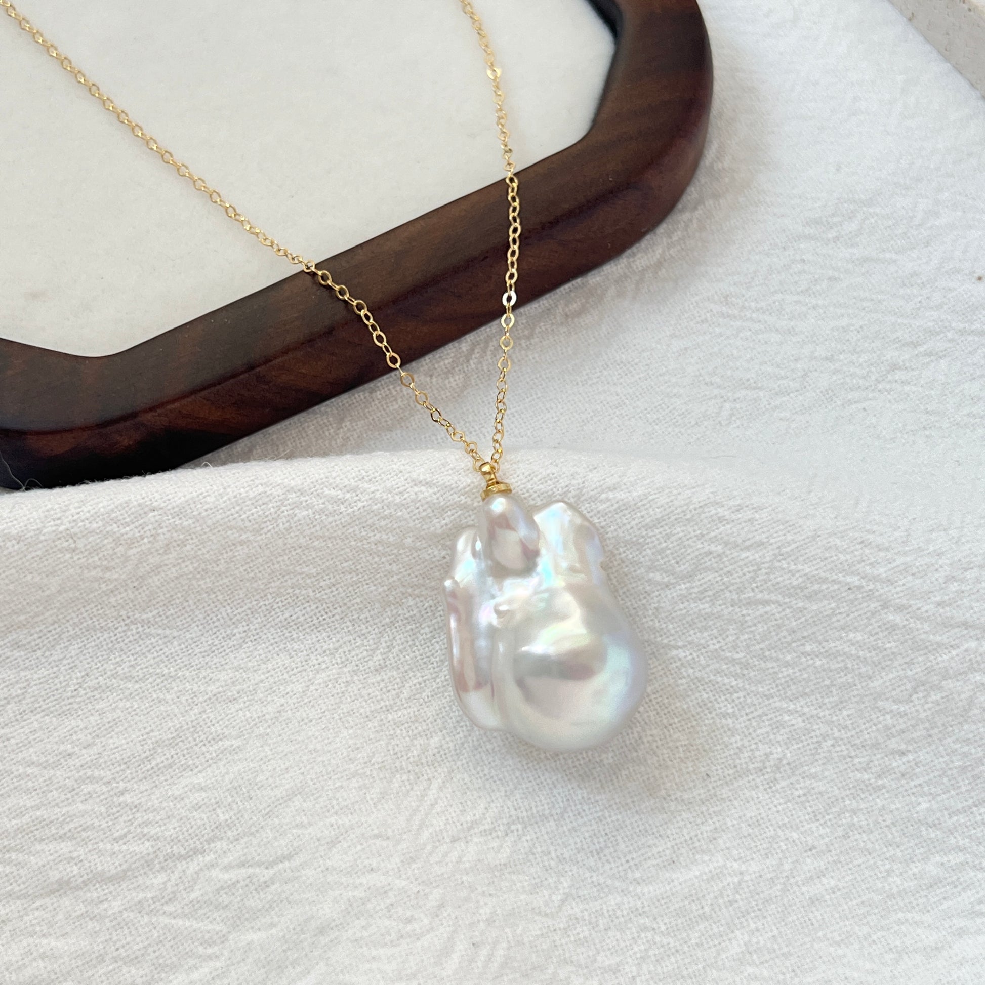 Side view of 14K gold-filled necklace showing large baroque pearl detail
