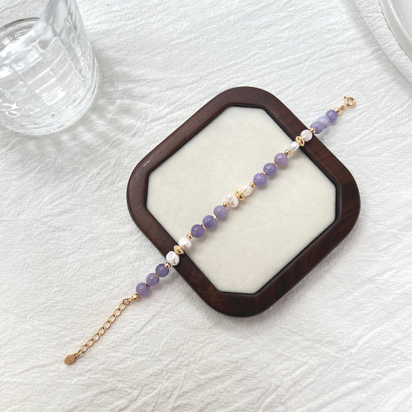 Side view of 18K gold baroque pearl and lepidolite gemstone bracelet