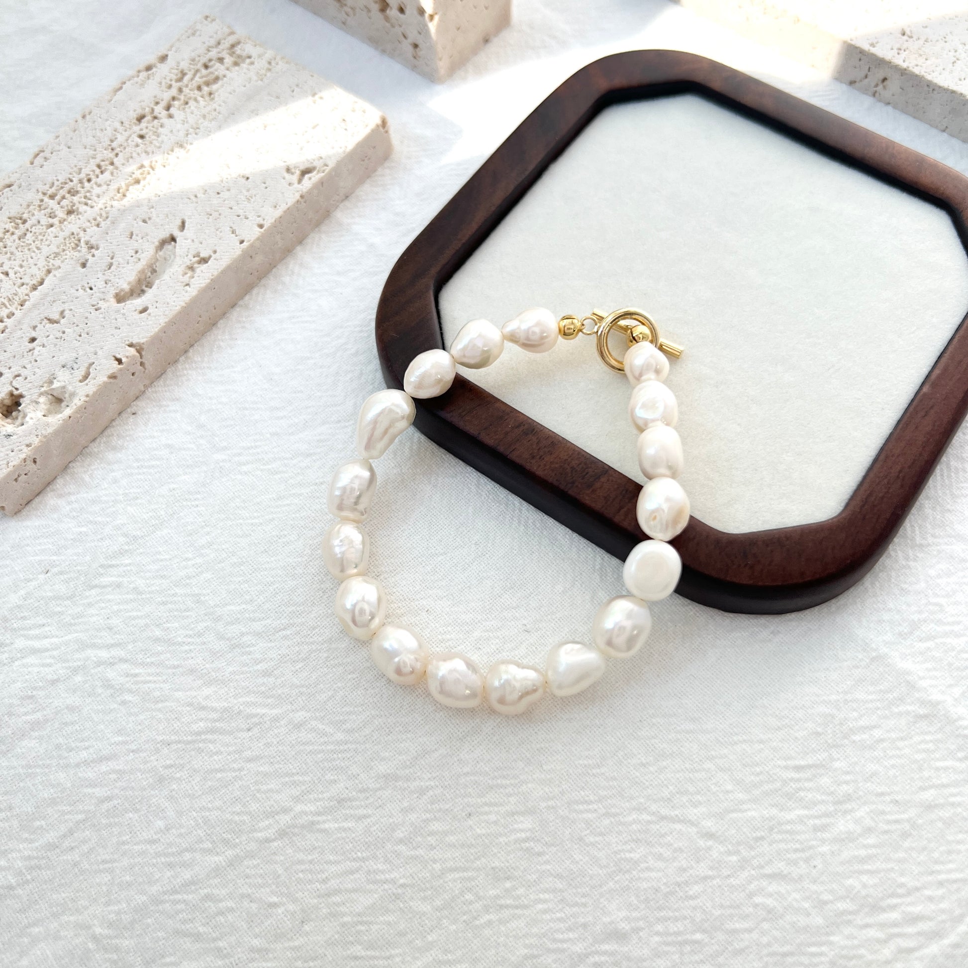 Close-up of 14K gold-filled baroque pearl bracelet, highlighting pearl texture and delicate craftsmanship