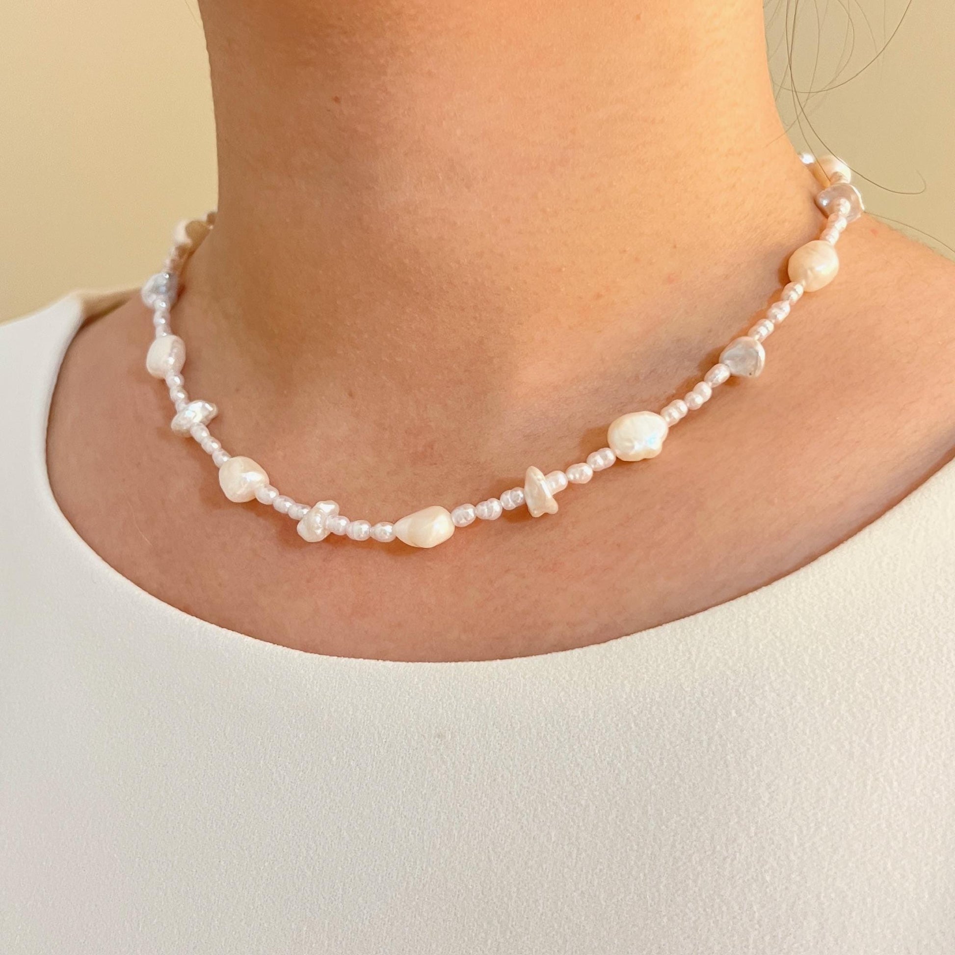 Woman wearing freshwater baroque irregular pearl beaded necklace, perfect for weddings or bridesmaids