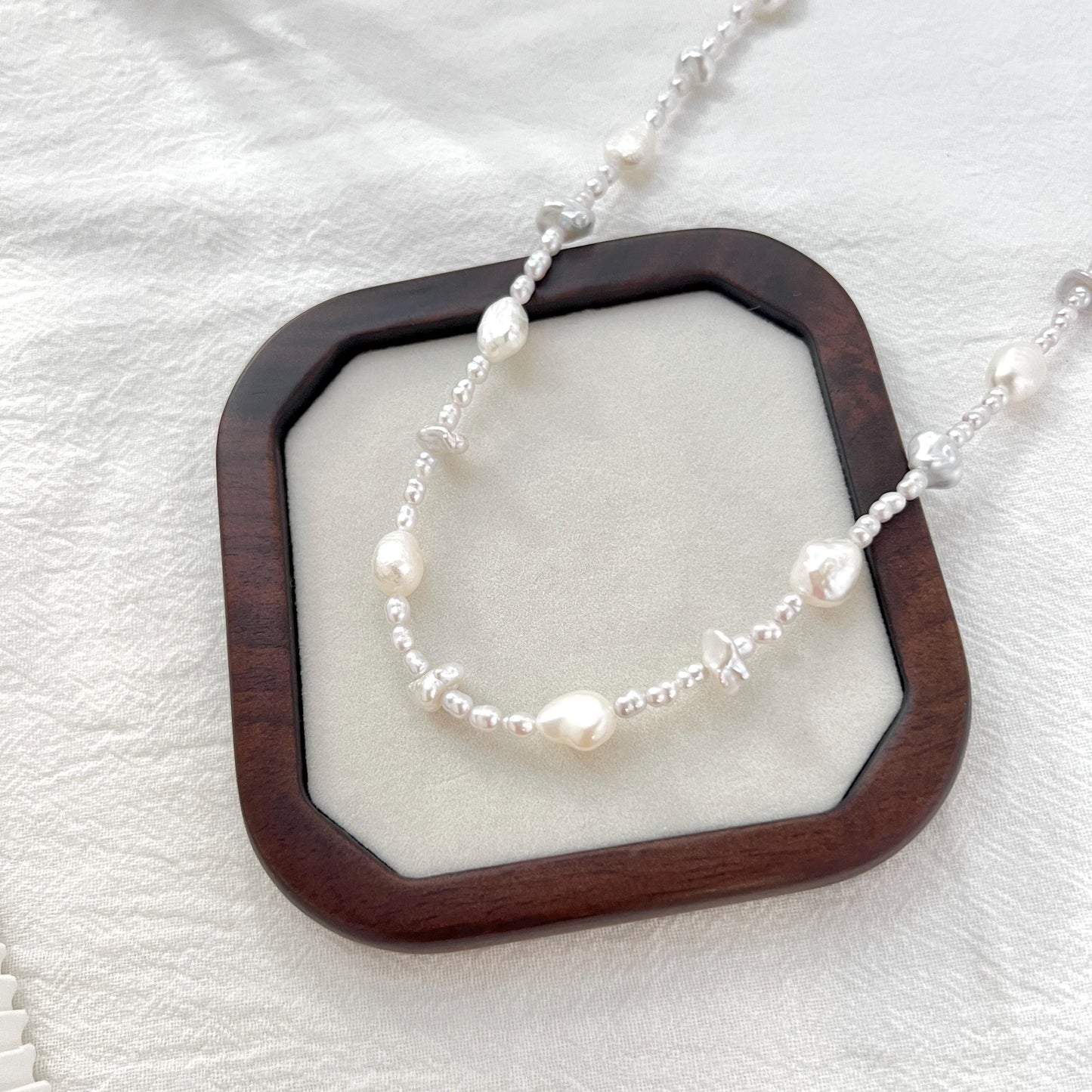 Close-up of freshwater baroque irregular pearl beaded necklace, highlighting unique irregular shapes and luster