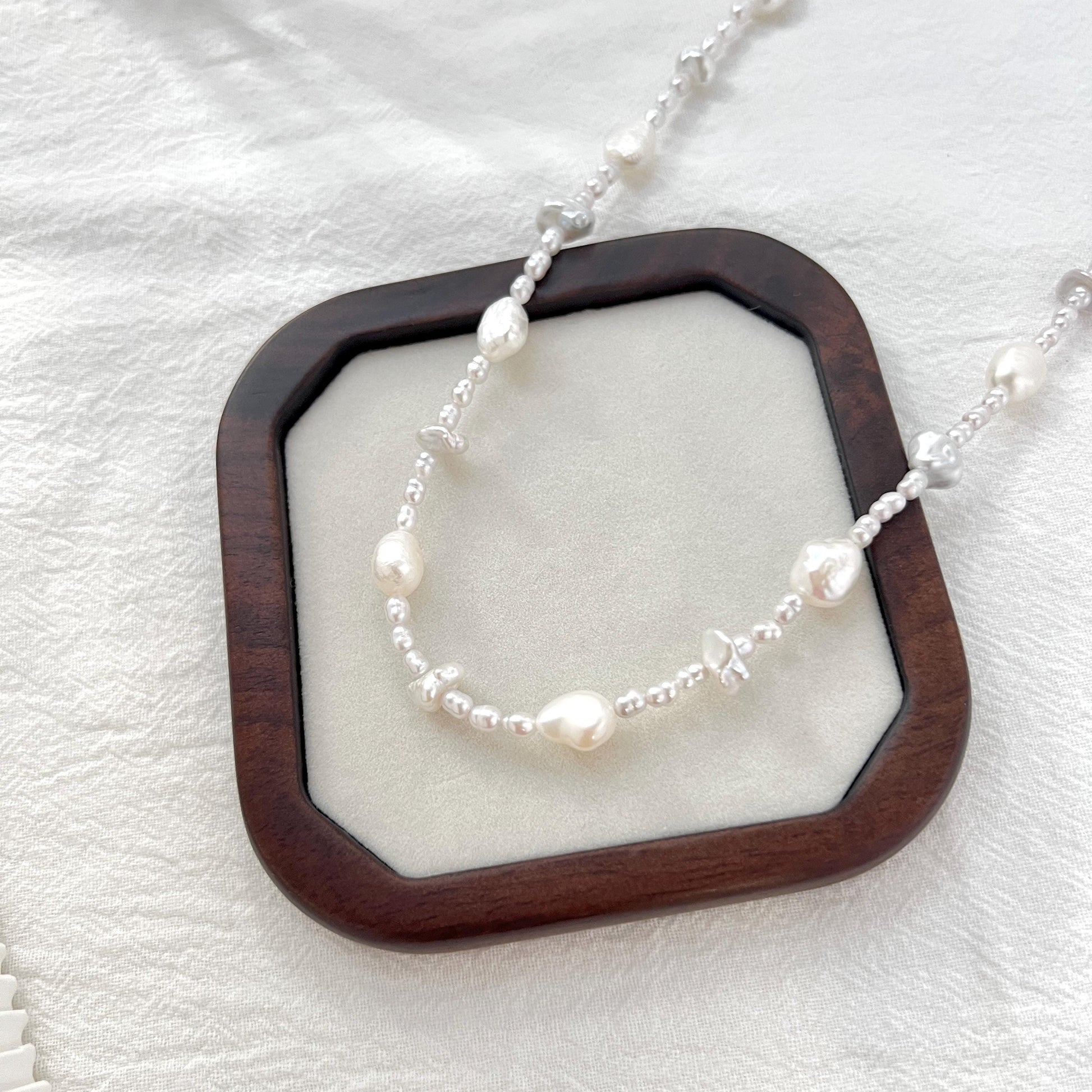 Close-up of freshwater baroque irregular pearl beaded necklace, highlighting unique irregular shapes and luster