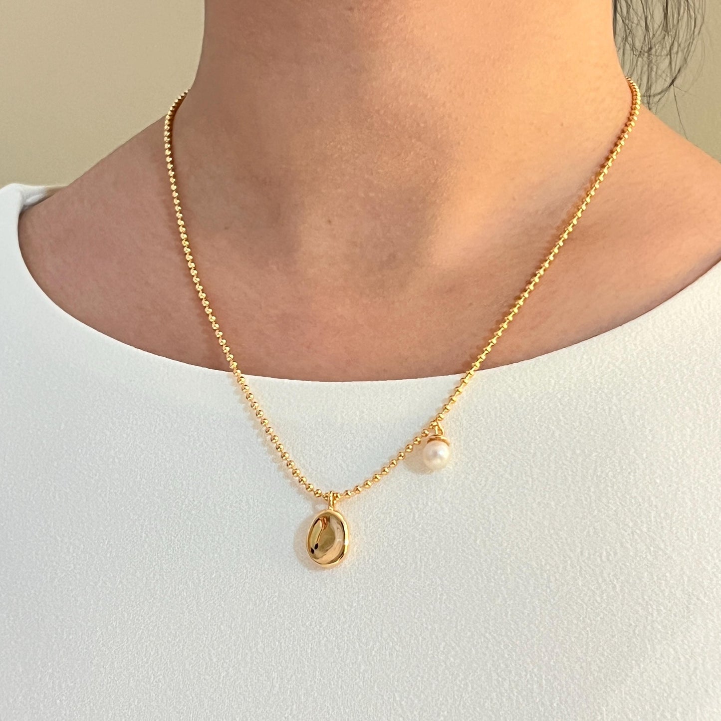 Golden Bean Pendant With Petite Freshwater Pearl Charm Necklace