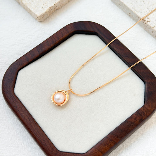 close up of 18k gold freshwater pearl pendant necklace delicate chain and pearl