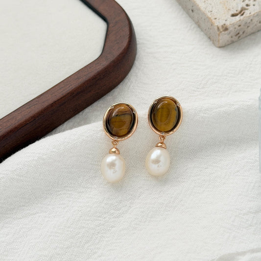 Vintage tiger’s eye drop earrings with natural freshwater pearls and warm gold settings.