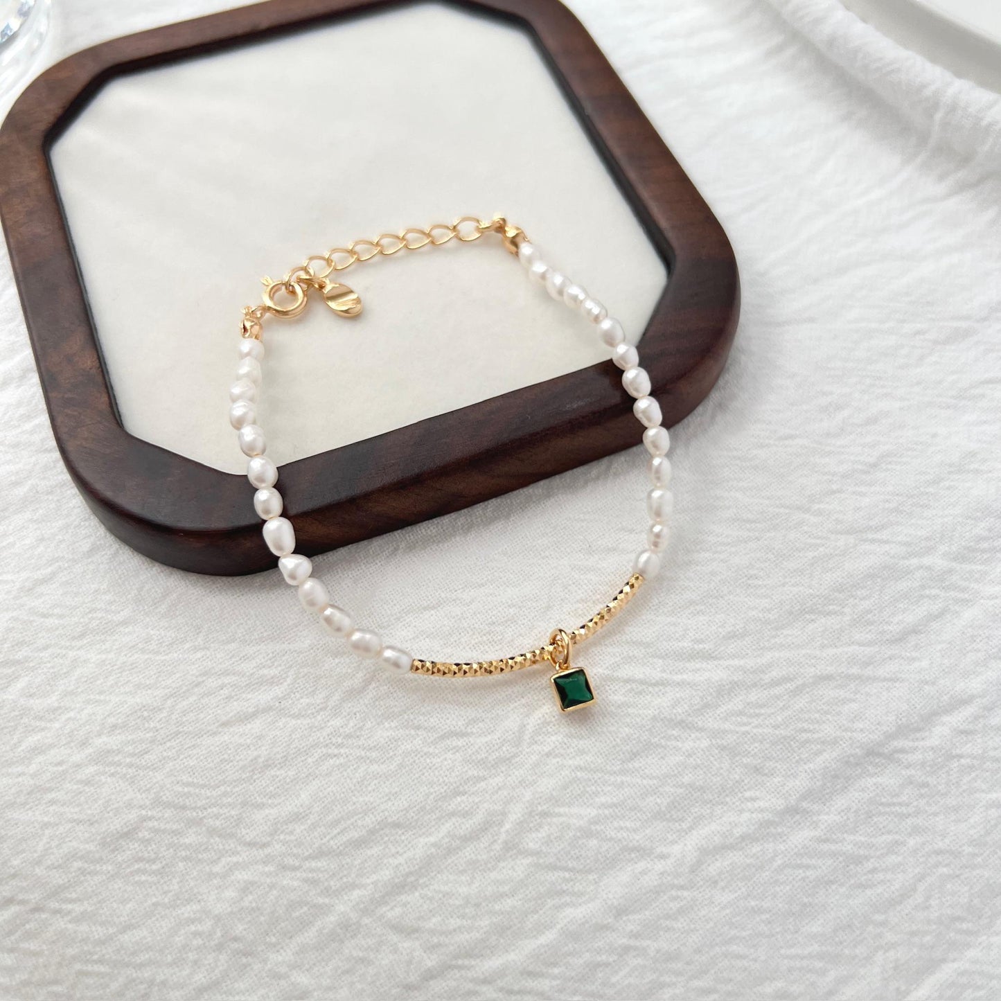 Ocealine Jewelry 18K gold baroque pearl bead bracelet with green zircon charm — brand shot