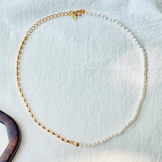 Detail of clasp and extension chain on two-tone baroque pearl and gold beaded choker necklace, minimalist handmade jewelry.