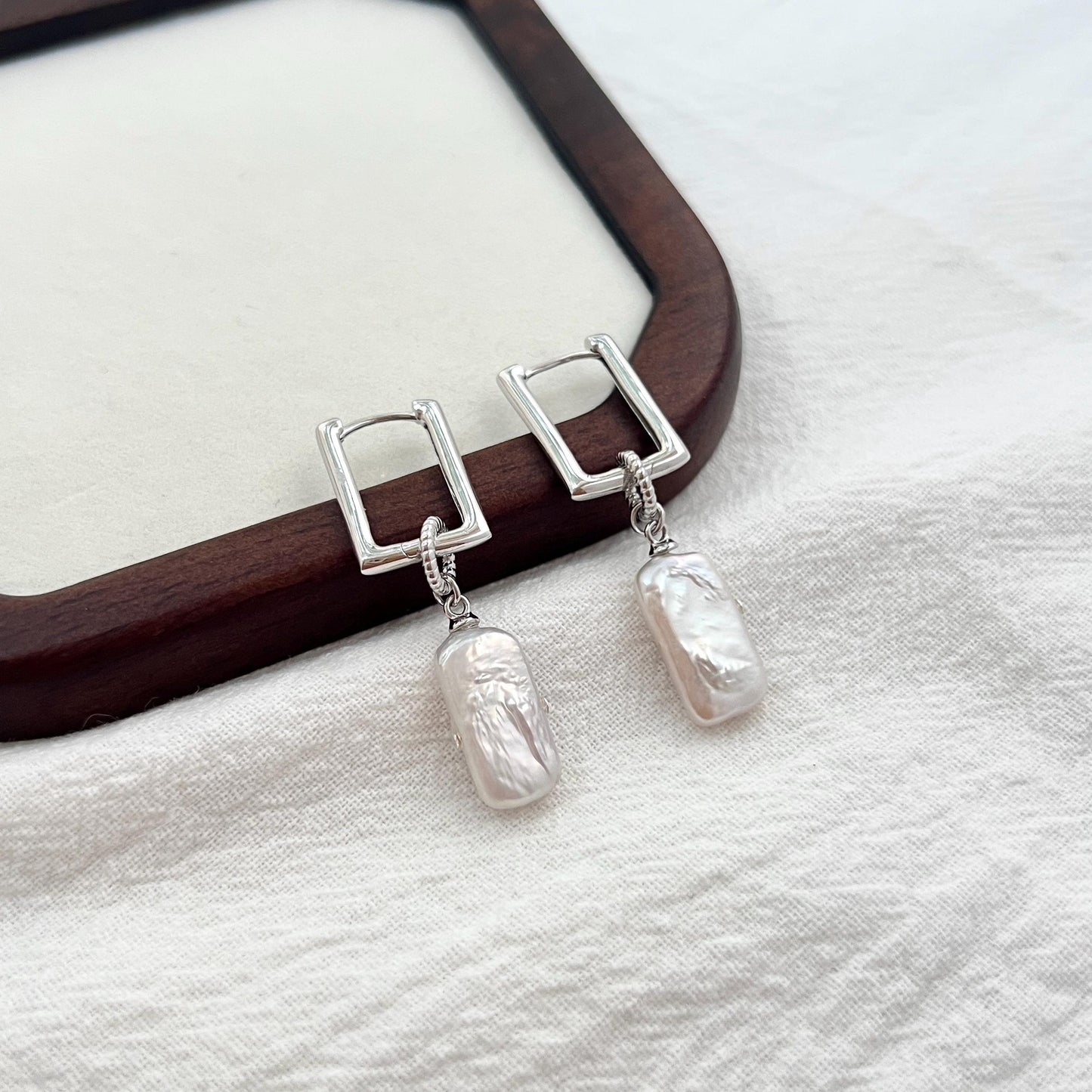 Silver rectangle baroque pearl dangle earrings shown from multiple angles, minimalist and elegant design