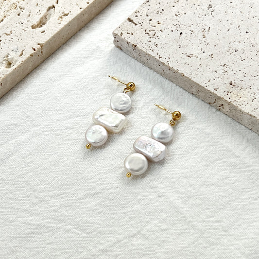 Side view of 14K gold baroque pearl coin rectangle earrings showing natural pearl luster