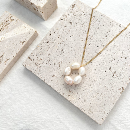 Close-up of 14K gold-filled baroque pearl flower necklace, showing delicate floral design