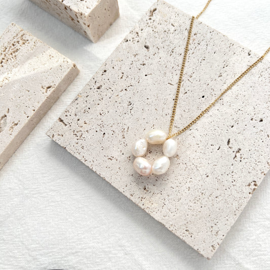 Close-up of 14K gold-filled baroque pearl flower necklace, showing delicate floral design