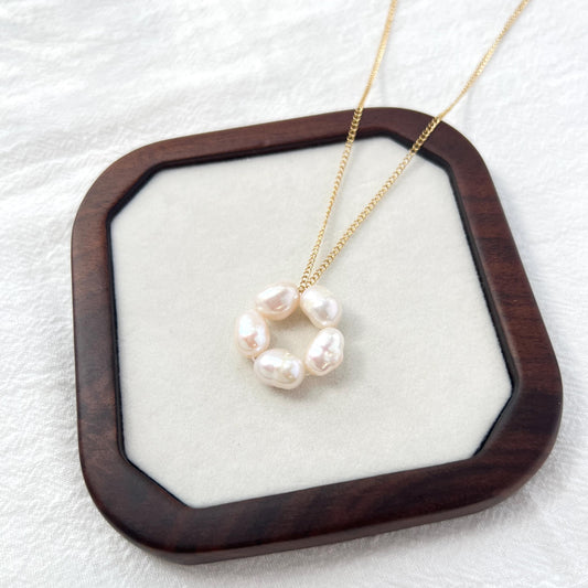Close-up of 14K gold-filled baroque pearl flower necklace, showing delicate floral design