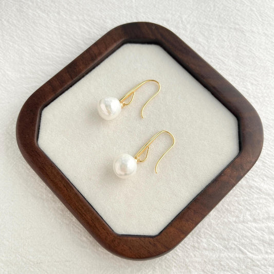 Edison baroque pearl hook earrings in 18K gold shown from multiple angles, timeless minimalist design