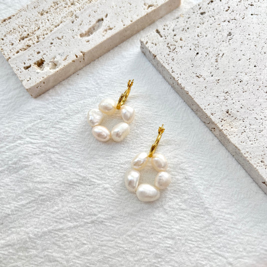 Woman wearing 18K gold baroque pearl flower drop earrings, showcasing elegant bridal style