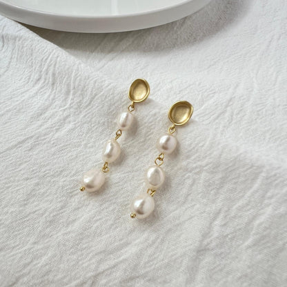 Close-up of baroque freshwater pearls with matte gold finish