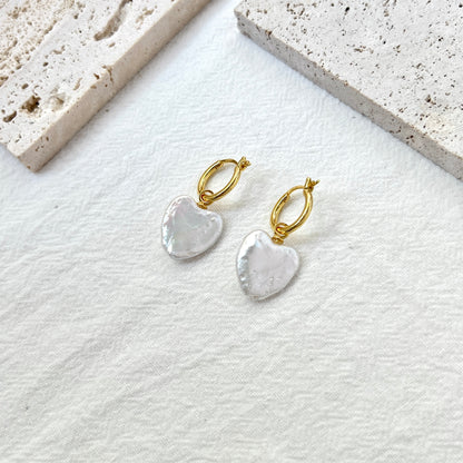 Close-up of heart baroque freshwater pearls with gold hoops