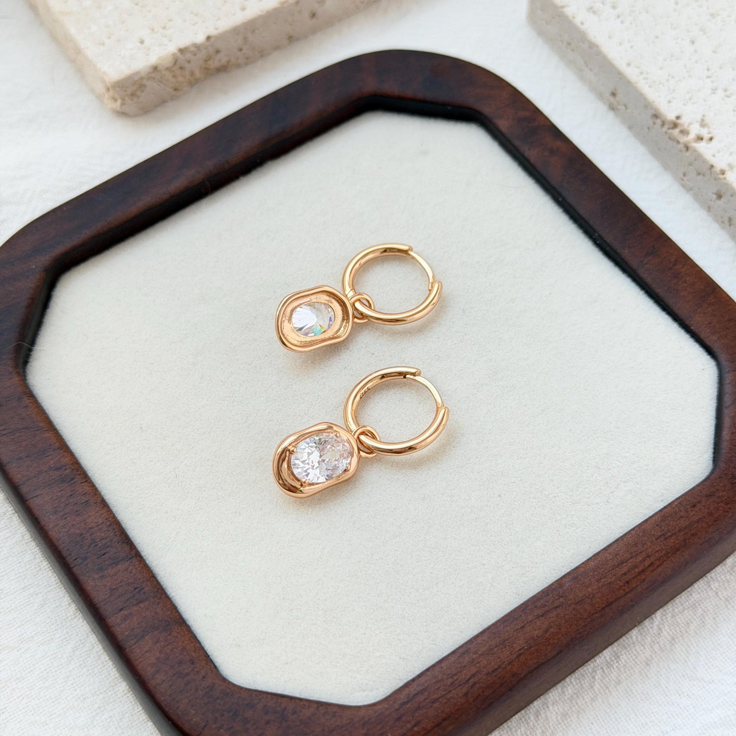 minimalist 18k gold hoop earrings with sparkling oval cut cz stones
