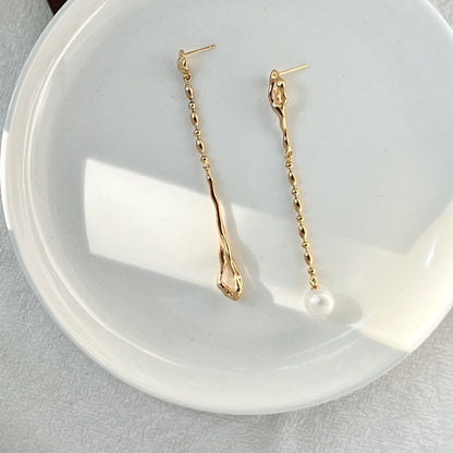 Ocealine Jewelry branded image featuring 18K gold asymmetrical pearl drop earrings