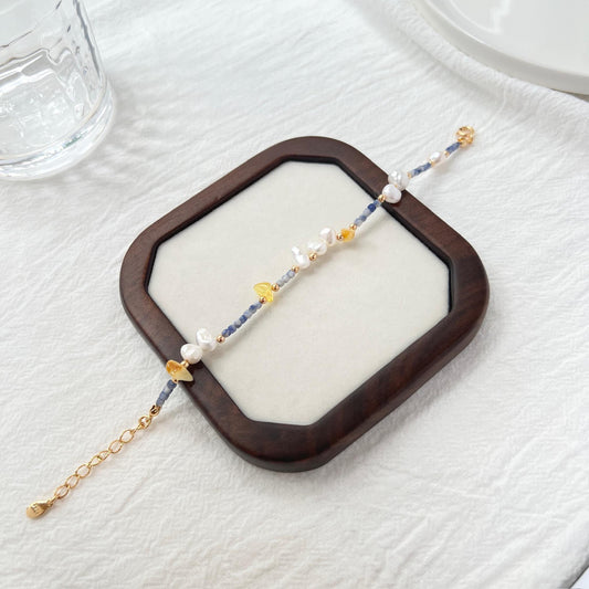 Side view showing 18K gold beaded bracelet with colorful stones