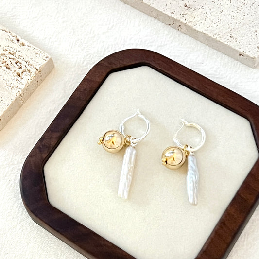 Woman wearing 14K gold-filled baroque pearl drop earrings, showcasing elegant bridal style