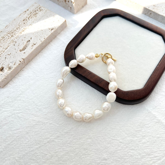 Close-up of 14K gold-filled baroque pearl bracelet, highlighting pearl texture and delicate craftsmanship