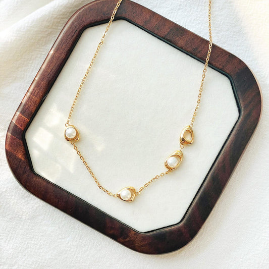 Close-up of natural freshwater pearls on 18K gold minimalist choker necklace, delicate handmade jewelry.