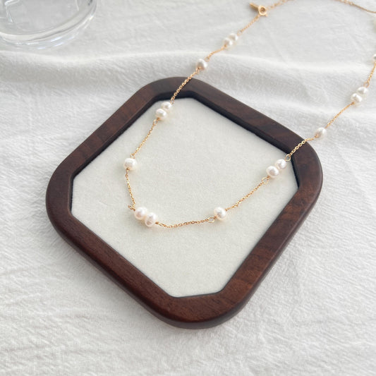Close‑up of natural freshwater baroque pearls and gold‑vermeil beads on 18K gold over sterling silver chain, handmade minimalist jewellery.