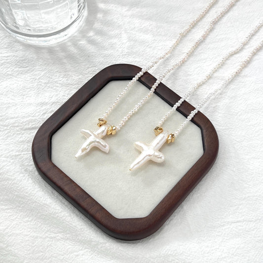 Handmade freshwater pearl cross pendant necklace with gold clasp, minimalist and elegant jewelry for women.