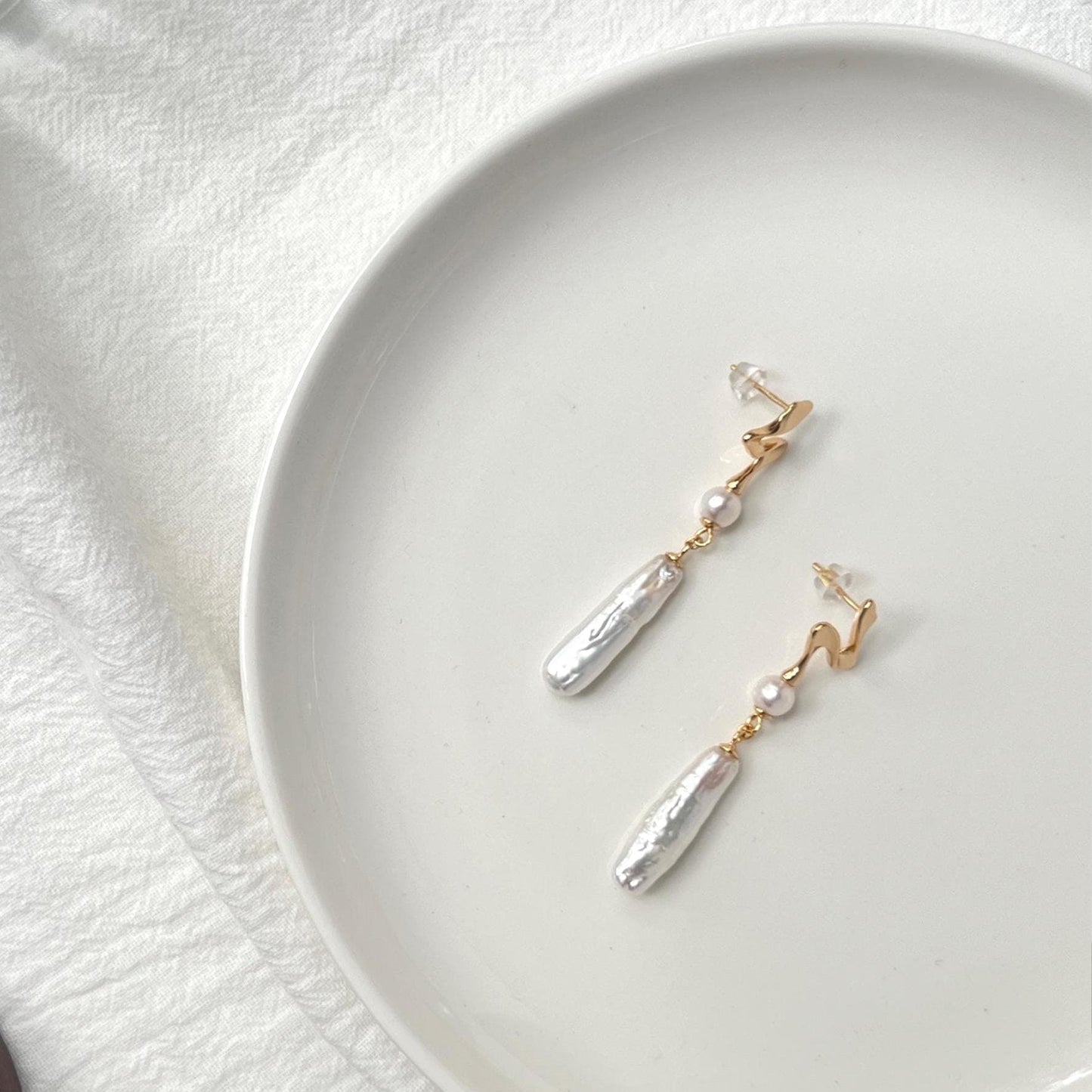 gold sculptural stud earrings with long pearl drop, refined modern style