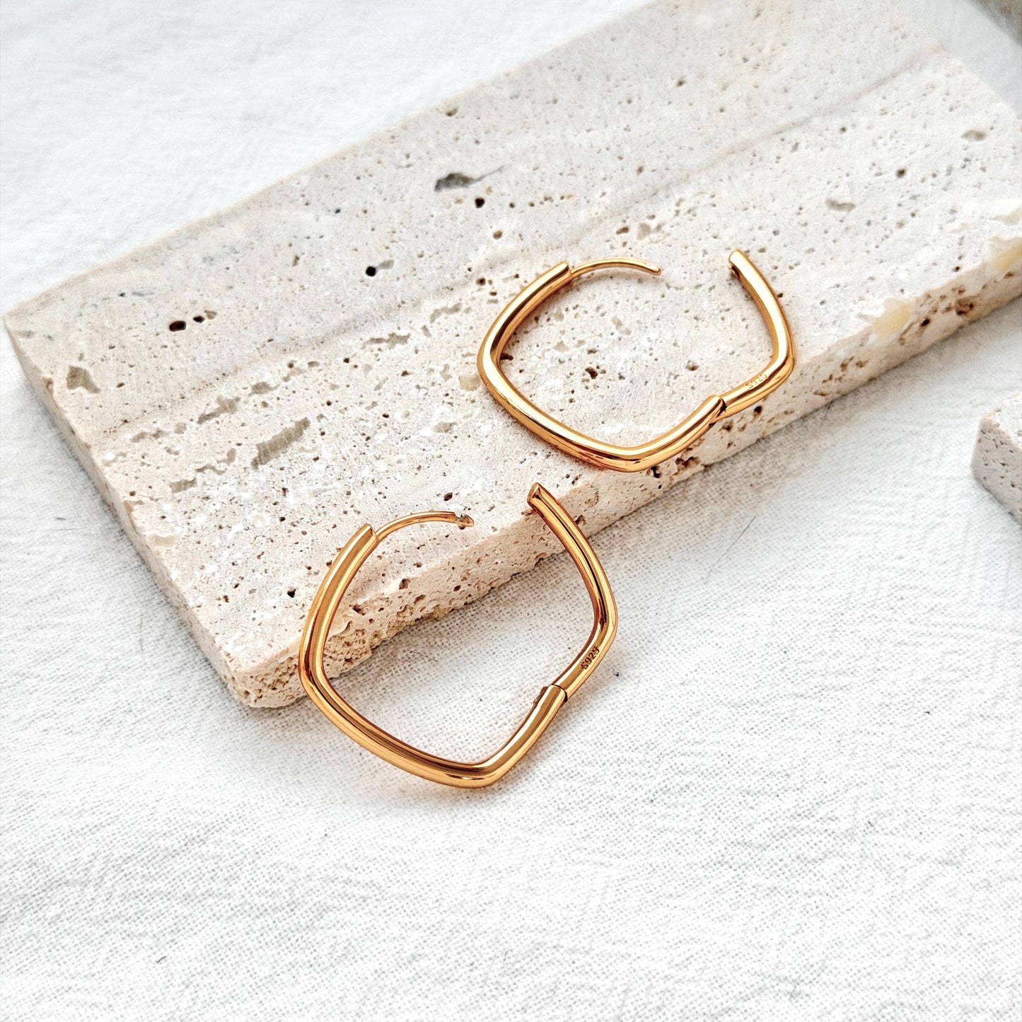 18k gold geometric square huggie hoop earrings on ear modern minimalist style
