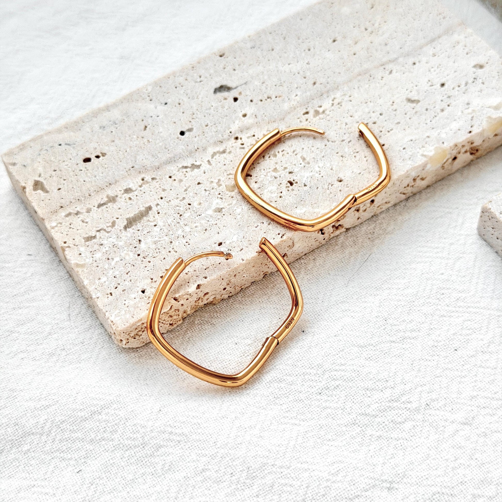 18k gold geometric square huggie hoop earrings on ear modern minimalist style
