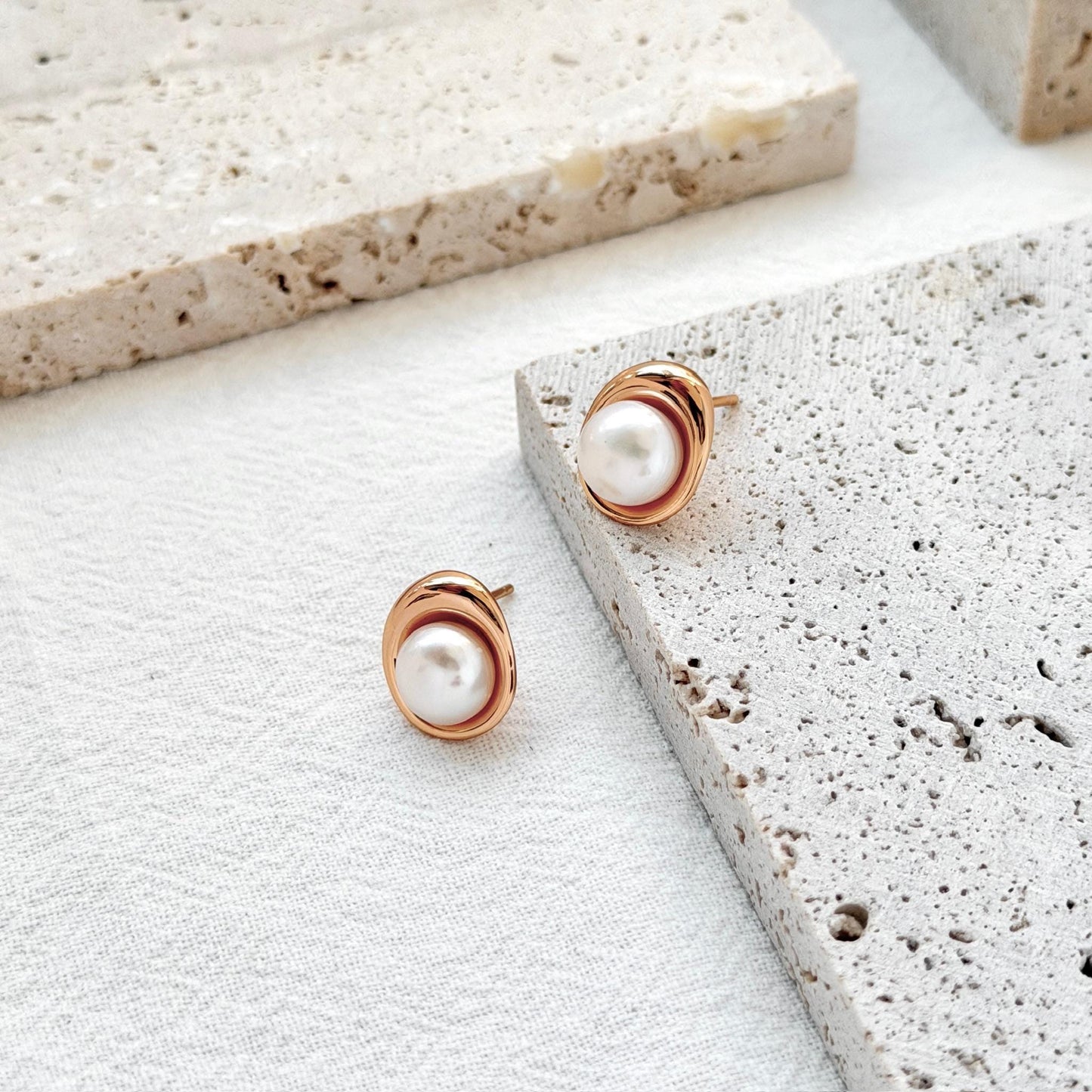 close up of 18k gold vintage freshwater pearl stud earrings texture and shine
