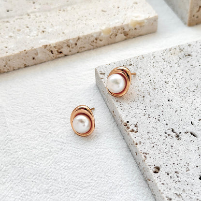 close up of 18k gold vintage freshwater pearl stud earrings texture and shine
