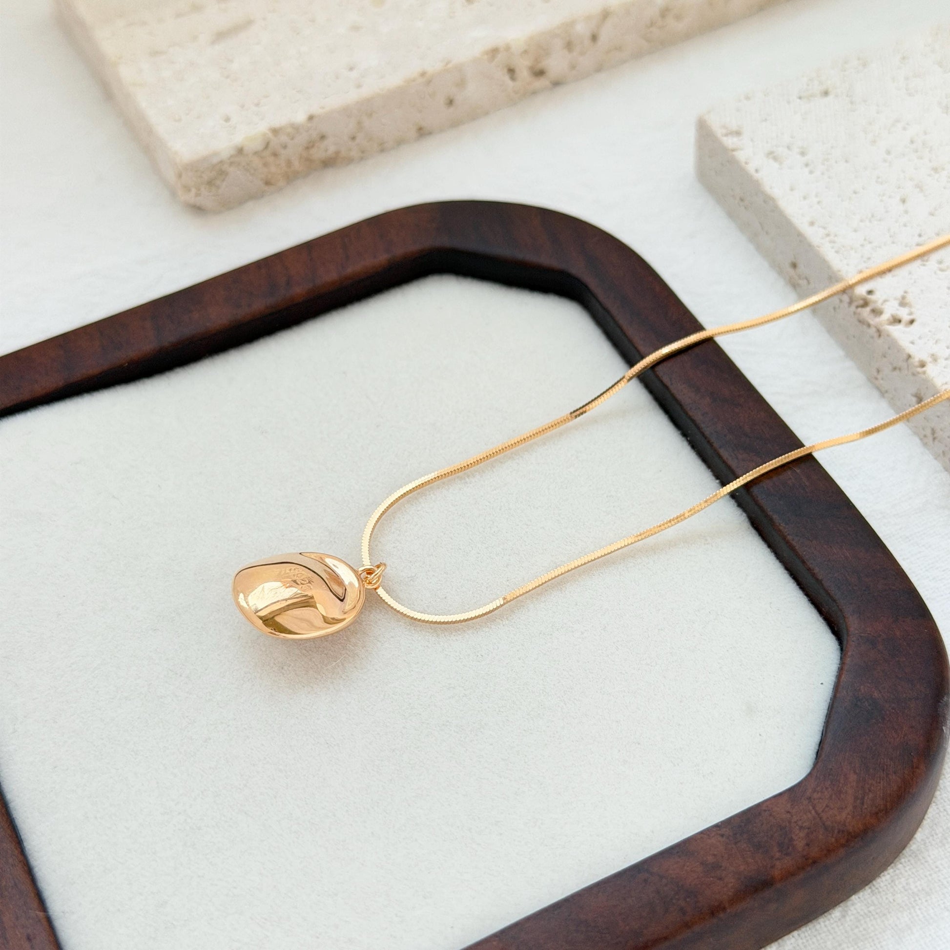 minimalist 18k gold freshwater pearl pendant necklace styled flatlay jewelry
