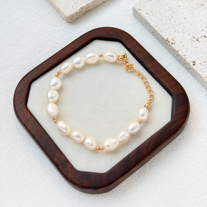close up of 18k gold freshwater baroque pearl bracelet texture and luster
