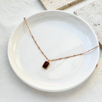 minimalist 18k gold tigers eye necklace styled flatlay jewelry
