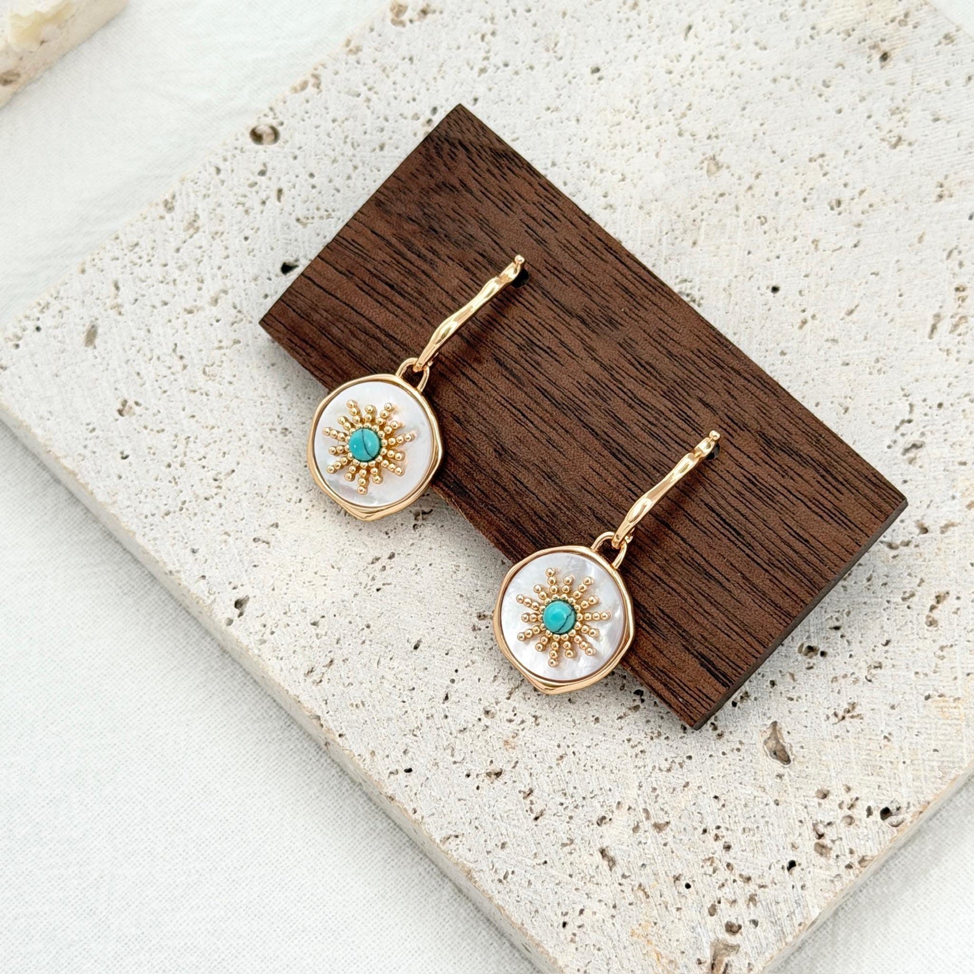 gold drop earrings with turquoise center and shell disc sun design