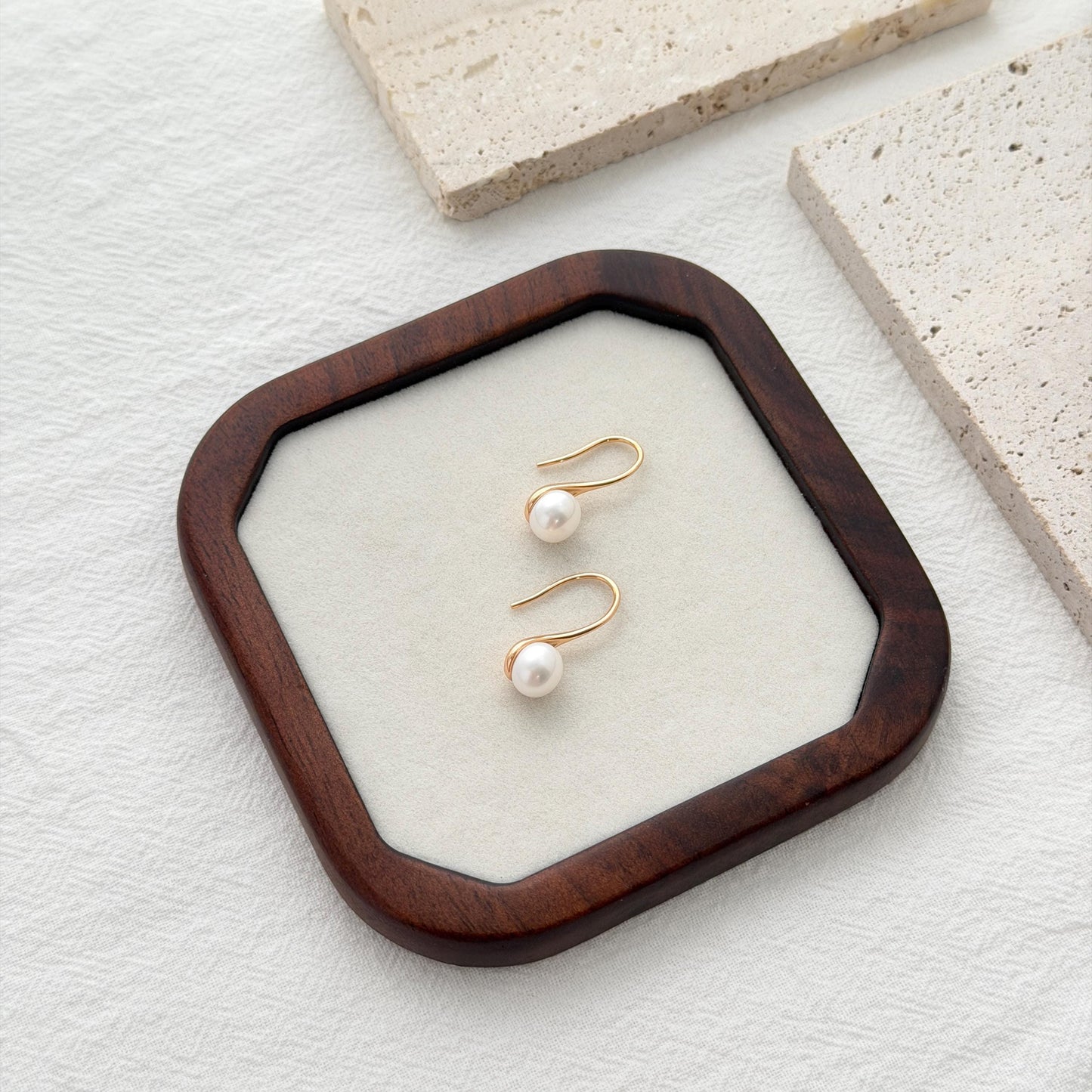 Freshwater pearl hook earrings crafted in gold over sterling silver with delicate organic shape
